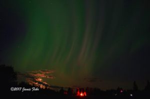 Northern Lights and small bonfire at Astotin Lake in Elk Island Park.